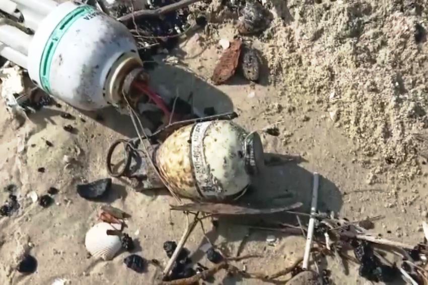 hand grenade found among the tar balls