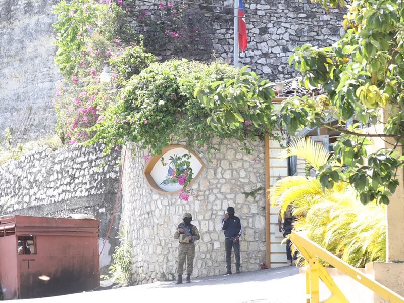 Members of the Haitian police and forensics patrol the area as they look for evidence outside of the presidential residence on Wednesday in Port-au-Prince, Haiti.
