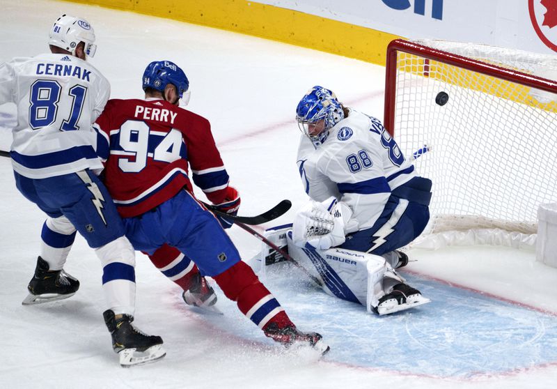 Tampa Bay Lightning goaltender Andrei Vasilevskiy makes a save on Montreal Canadiens' Corey Perry as Lightning's Erik Cernak