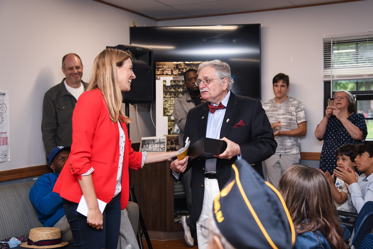 U.S. Rep. Mikie Sherrill presents a flag to Dan Gill at a ceremony after the Caravan of Heroes July 3, 2021