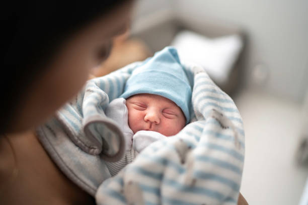 Women holding and looking at her godson at hospital baby stock pictures, royalty-free photos & images