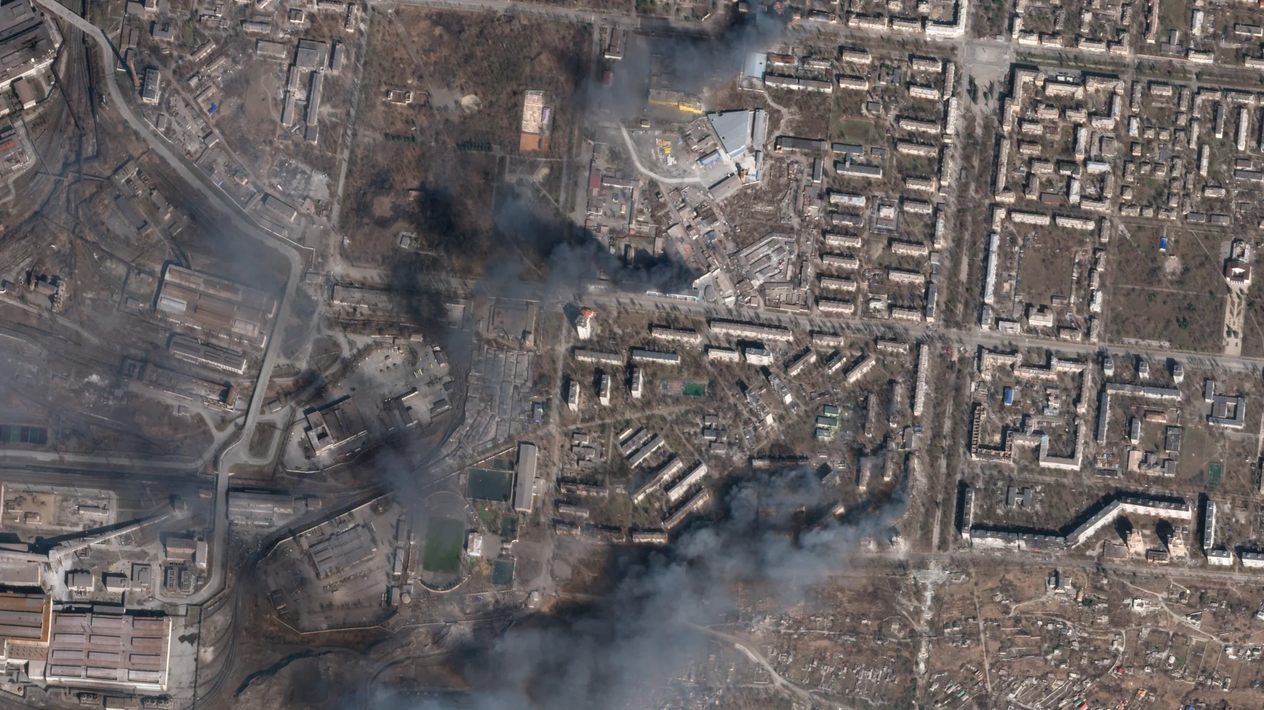 In this satellite photo from Planet Labs PBC, multiple civilian buildings burn amid Russian strikes on the Livoberezhnyi District of Mariupol, Ukraine, Sunday, March 20, 2022.