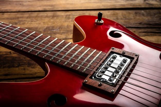 Red electric guitar on wooden floor