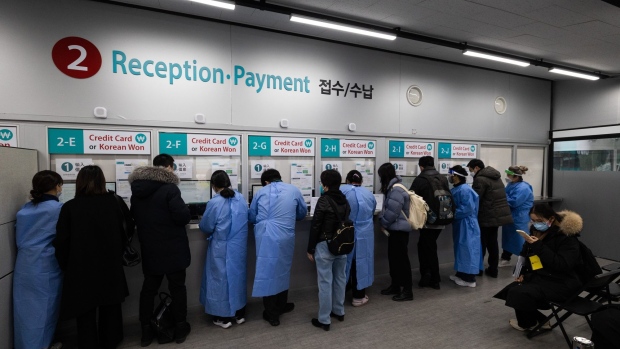 healthcare workers assist travelers arriving from china inside a covid 19 testing center at incheon airport on jan 6