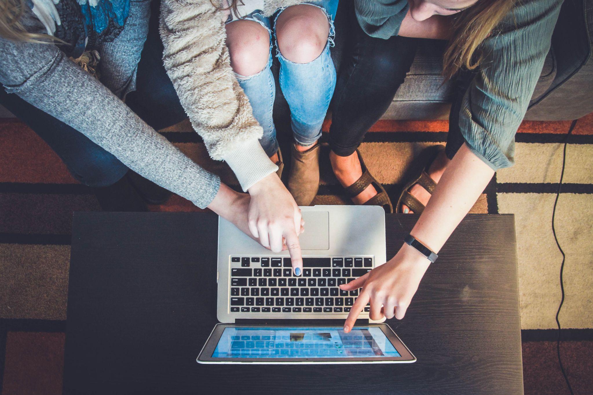 A group of people working together on a laptop.