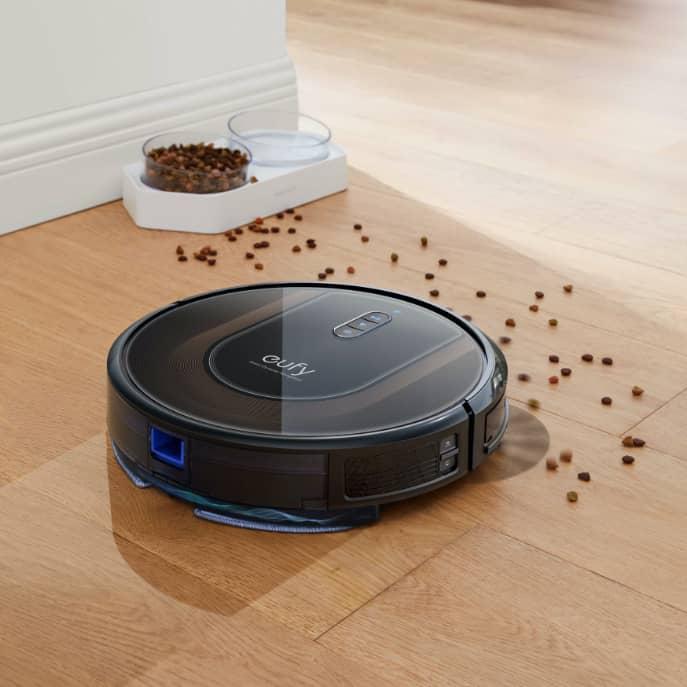 A robotic vacuum cleaner on a wood floor Description automatically generated