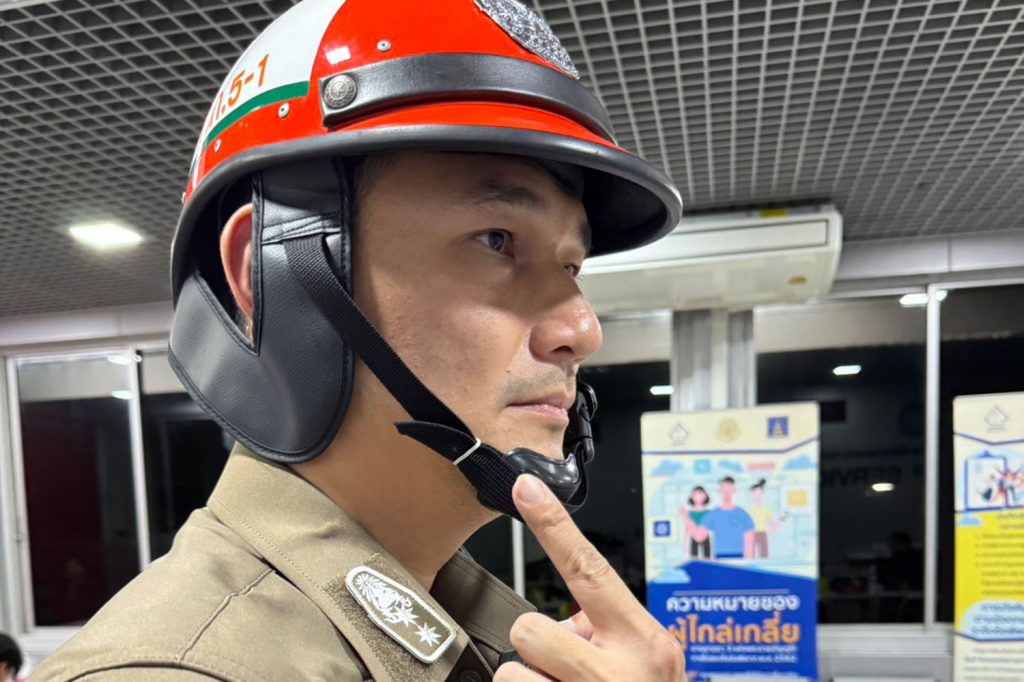 Pol Lt Col Darathorn Khajornsilp, deputy superintendent at Traffic Police division 5, points to his cheek where a motorist kicked him