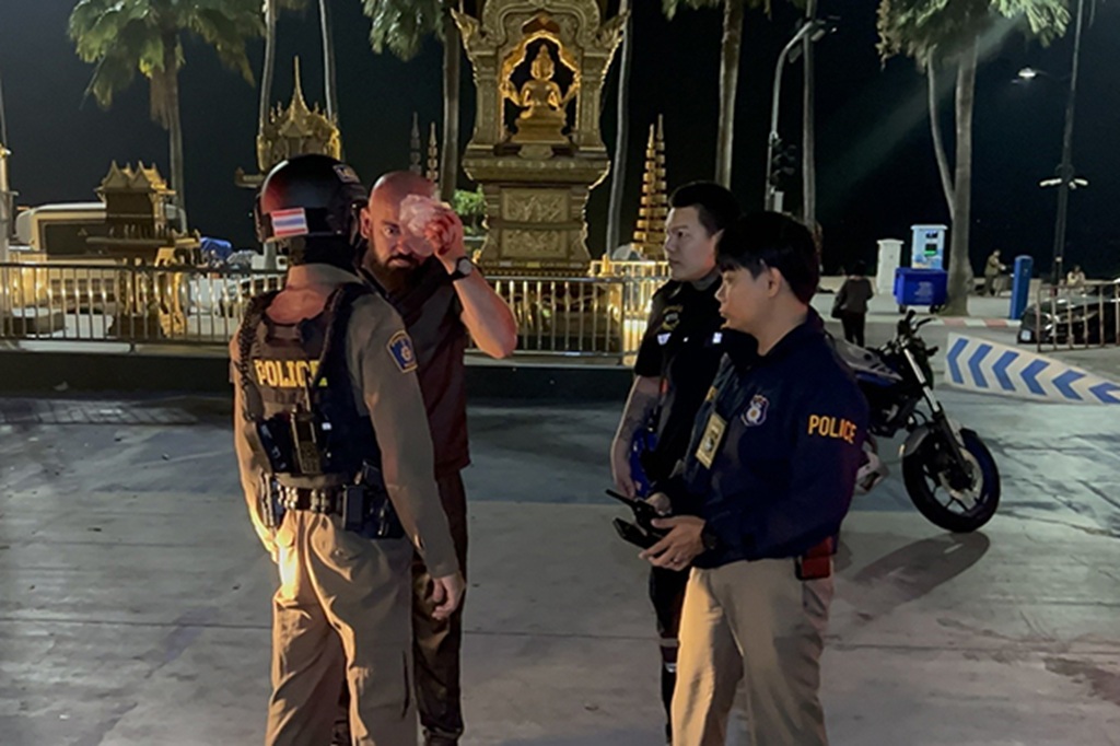 David Lelonek, a German visitor, talks with police