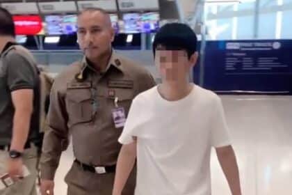 A Chinese fugitive wanted on an Interpol Red Notice is seen along with some of the evidence seized by immigration police officers at Suvarnabhumi airport