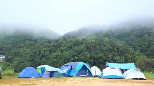 Tents set up in foggy mountains.