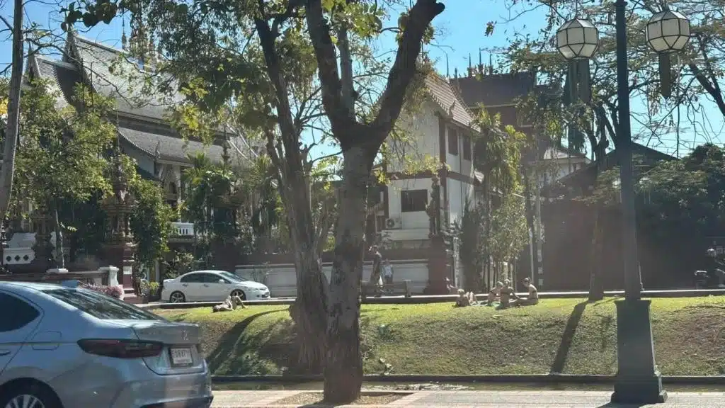 Tourist Sunbathing in Bikinis By Chiang Mai Temple