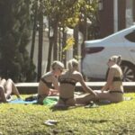Tourist Sunbathing in Bikinis By Chiang Mai Temple