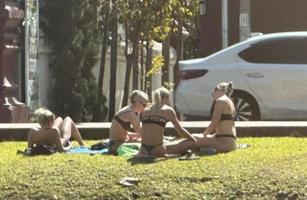 Tourist Sunbathing in Bikinis By Chiang Mai Temple