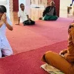 Former Monk Phra Khru Siriwiriyathada gives a wai to monks at Charoen Dhamma Forest Monastery