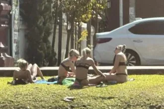 Tourist Sunbathing in Bikinis By Chiang Mai Temple